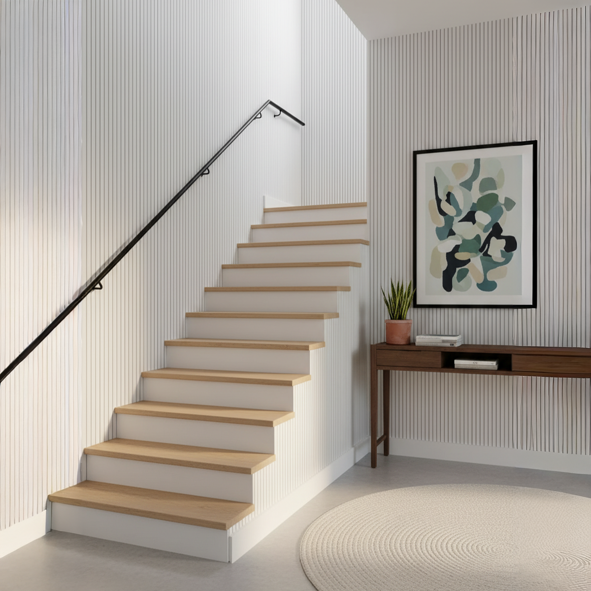 Staircase with wooden steps and a wall art piece in a modern interior setting.